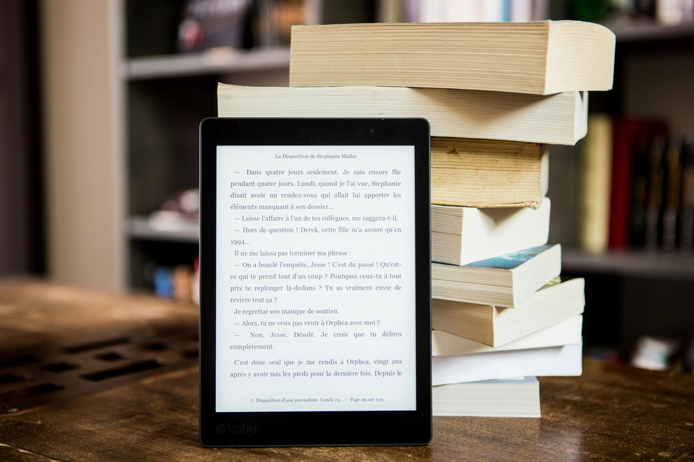 https://www.pexels.com/photo/black-tablet-computer-behind-books-1329571/