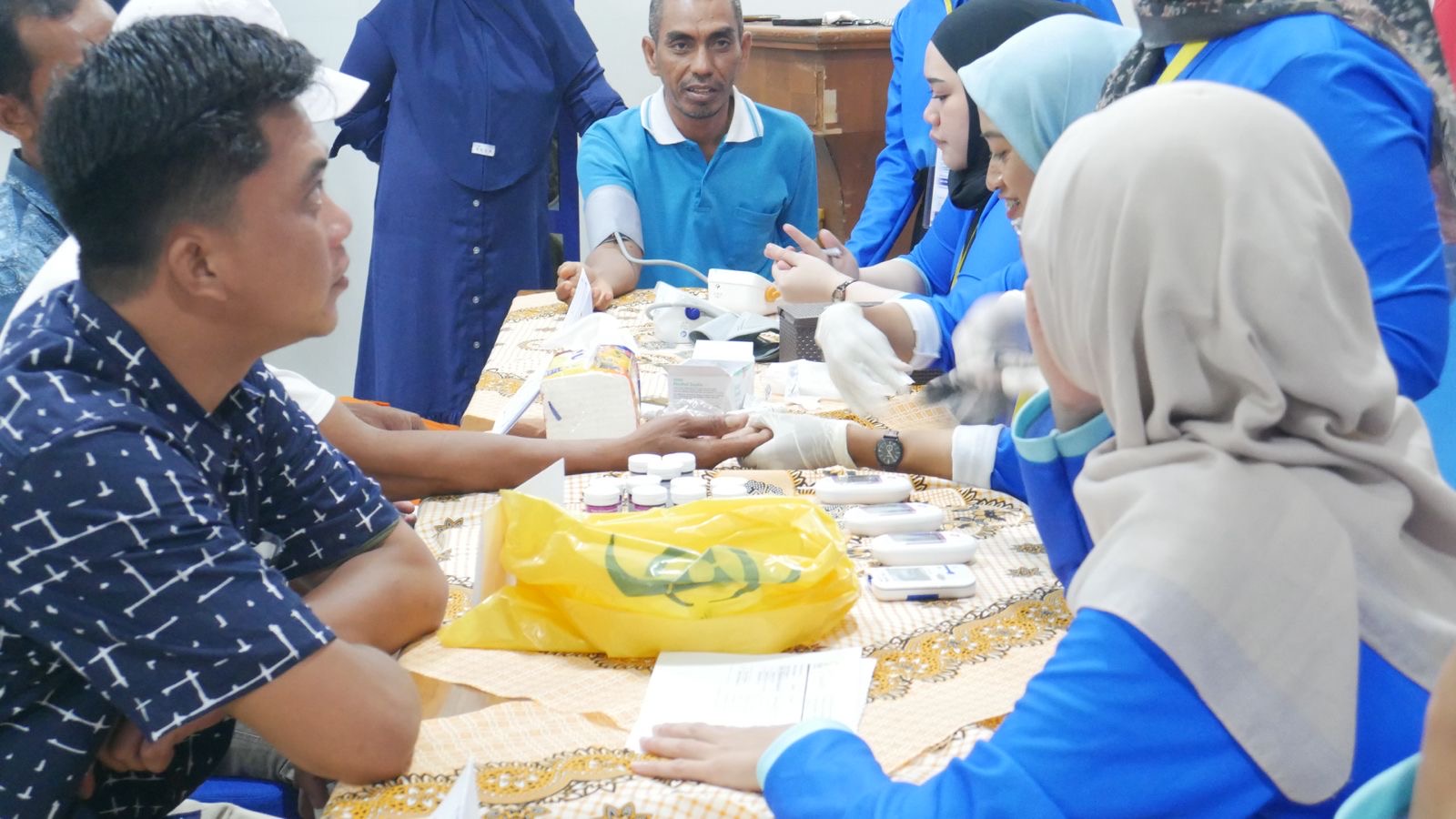 Skrining kesehatan berupa pengukuran tekanan darah, kadar gula sewaktu, kadar asam urat, kadar kolesterol, dan Hb yang dipimpin oleh apt. Tri Wahyuni, M.Biomed., Ph.D. | Dokumentasi Pribadi