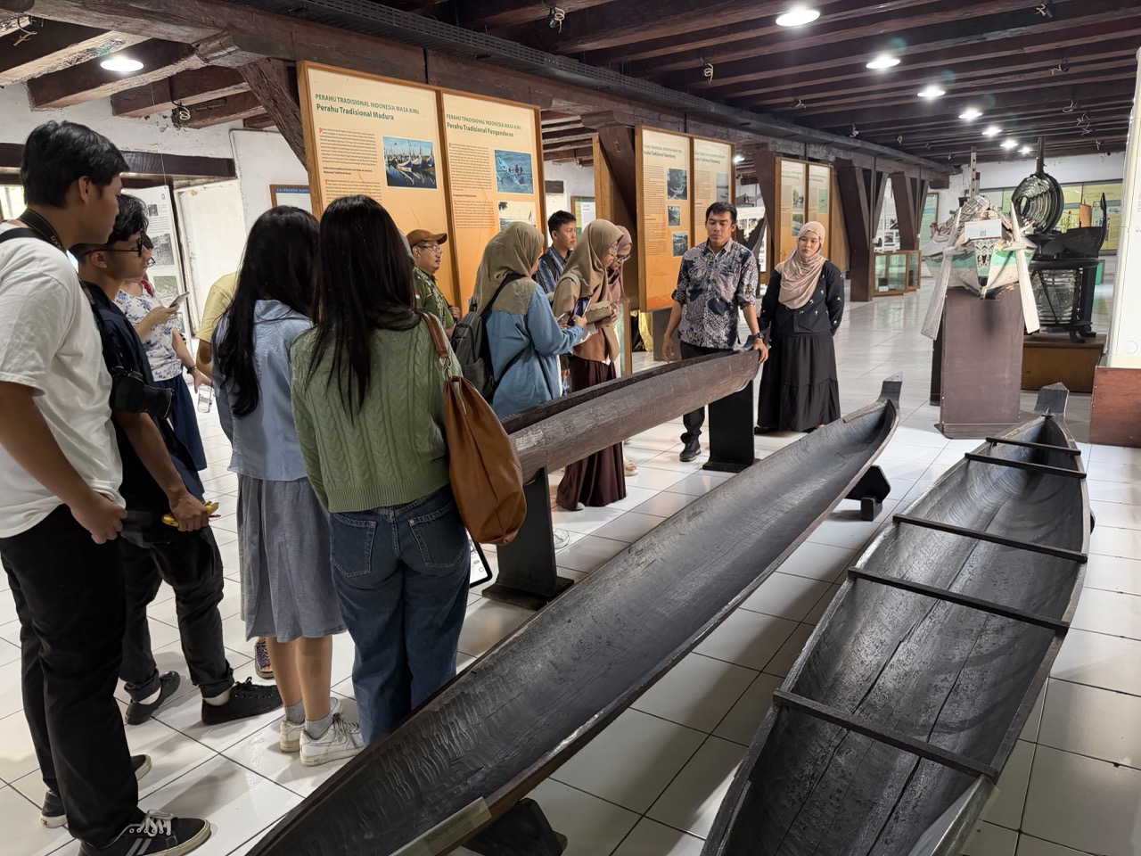 Writing-camp participants explore Museum Bahari’s maritime collections during a guided tour, turning historical artefacts into inspiration for new stories
