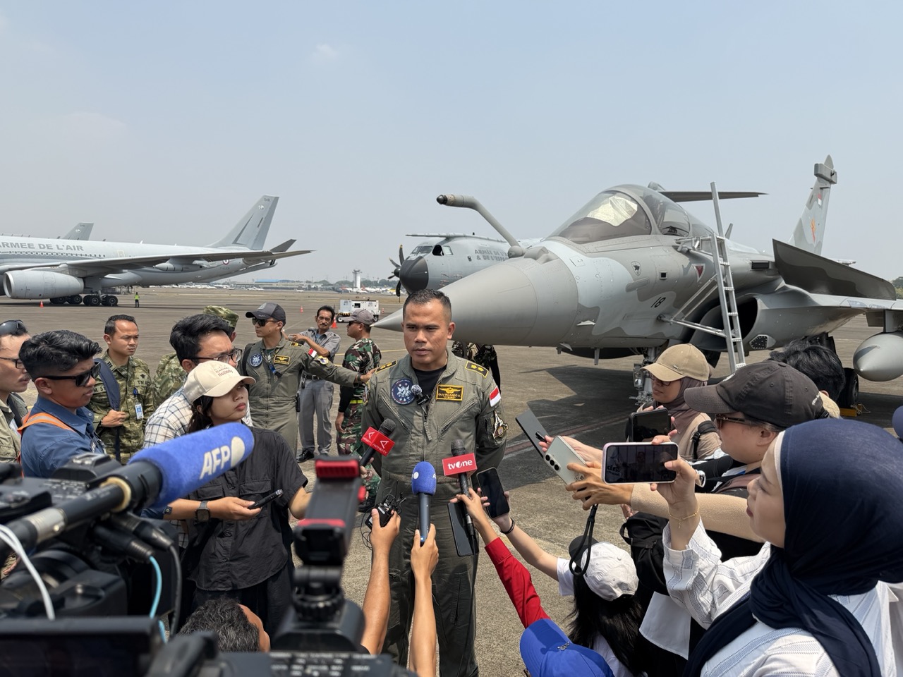 An Indonesian Air Force pilot speaks with journalists beside a Rafale fighter during the PEGASE 2026 Media Day at Halim Perdanakusuma Air Base in Jakarta.