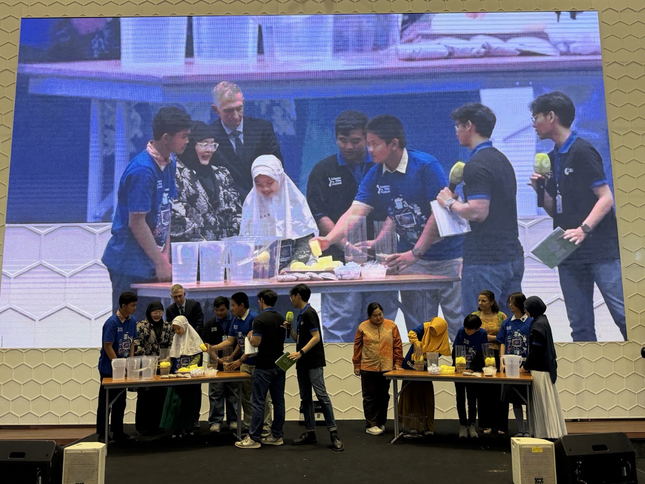 German Ambassador Ralf Beste and Goethe-Institut Regional Director Constanze Michel join students onstage for a science experiment at Science Film Festival 2026 in Jakarta.
