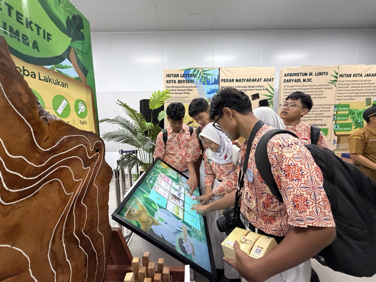 Students explore an interactive forest-themed display at the “Forests and Civilisation” exhibition at MRT Bundaran HI, Jakarta.