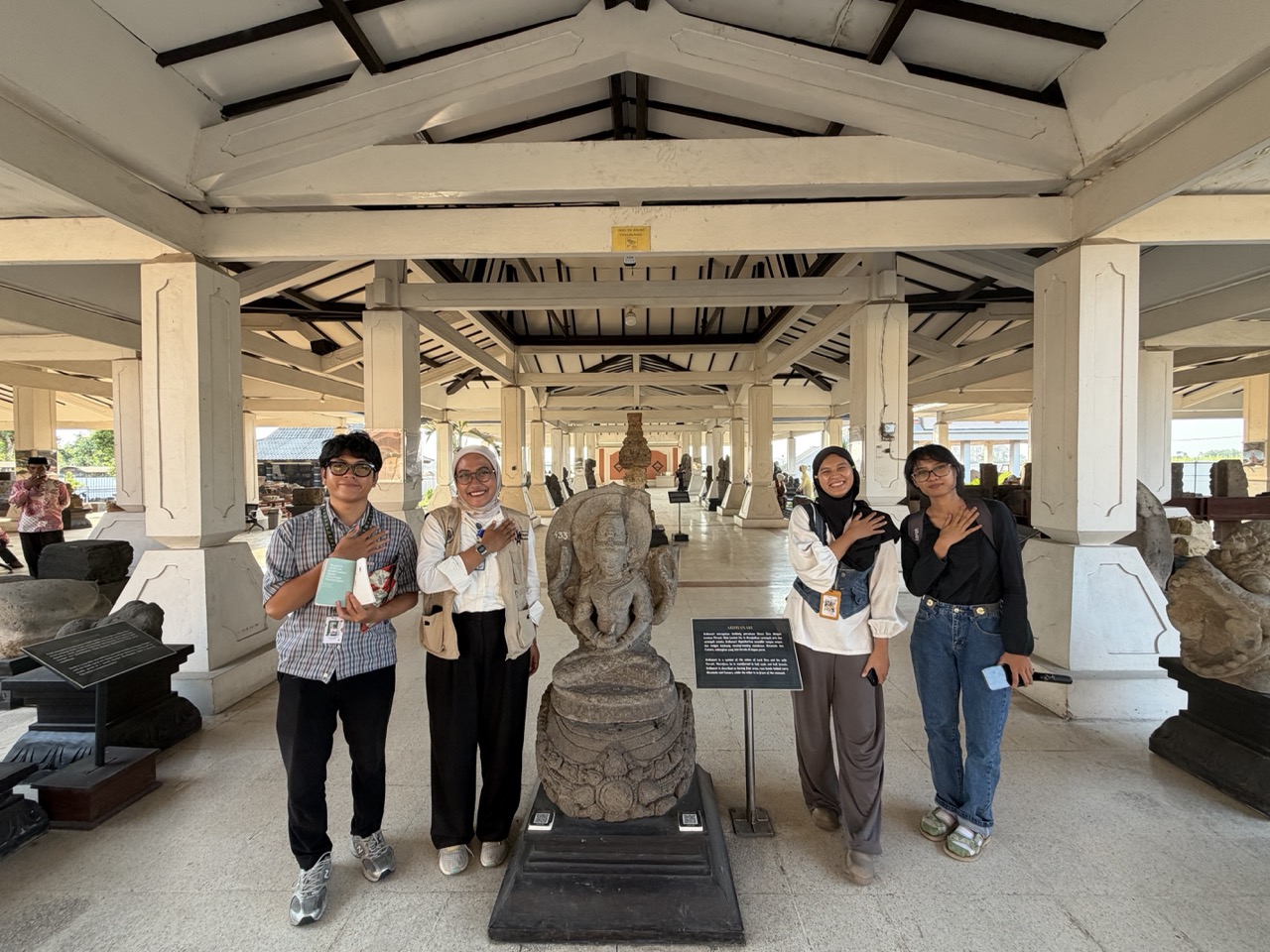 The MuseeID team poses beside a stone sculpture in Museum Majapahit’s collection gallery in Trowulan, East Java.