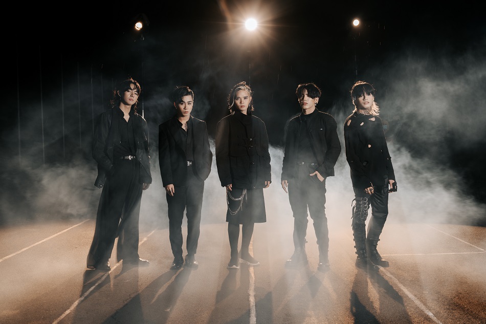 Filipino boyband SB19 posing in black outfits under stage lights with smoke effects